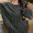 Femme debout portant un pyjama en pilou pilou gris et un ours en peluche marron